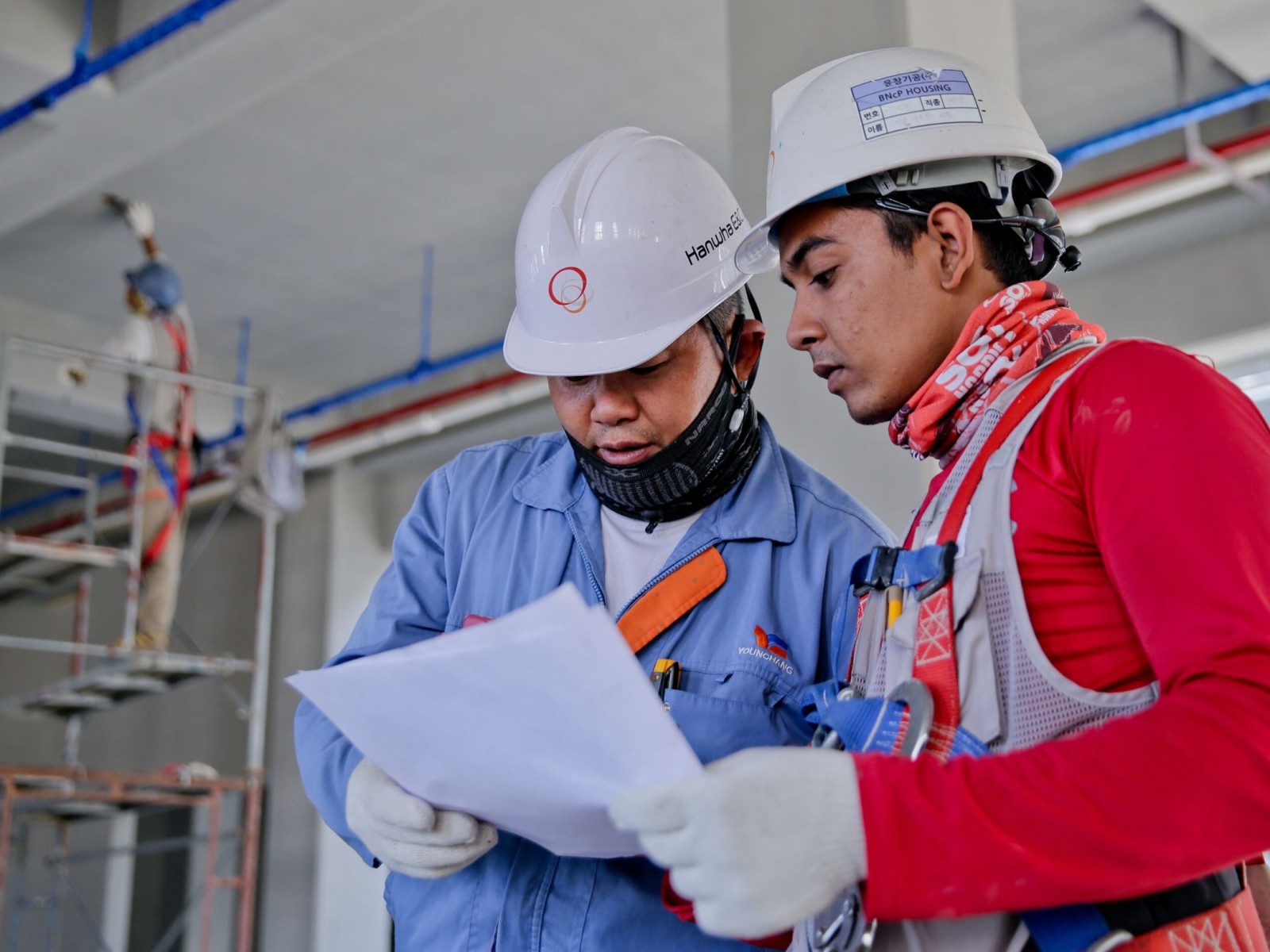 Men in hard hats looking at a report