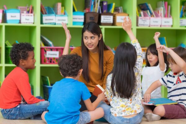 Teacher with students - GCCS Business