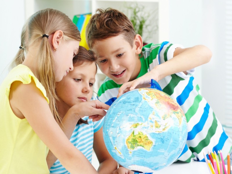 Kids studying the globe