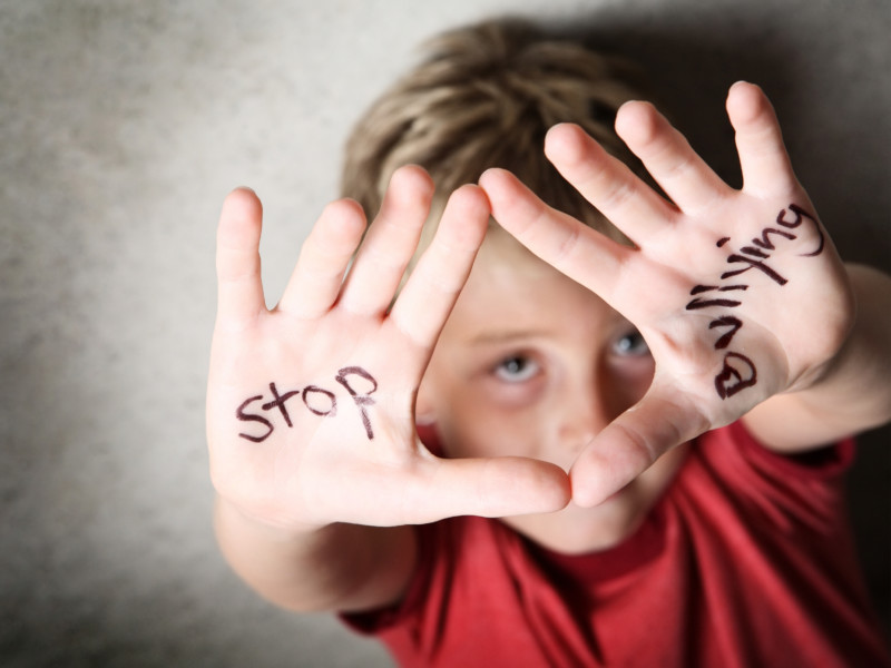 Boy with stop bullying written on hands