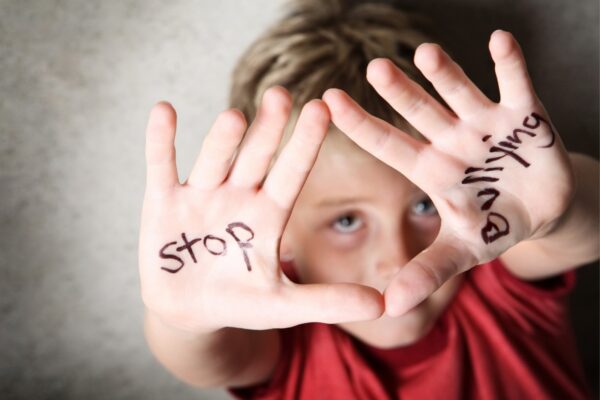 Boy with stop bullying written on hands