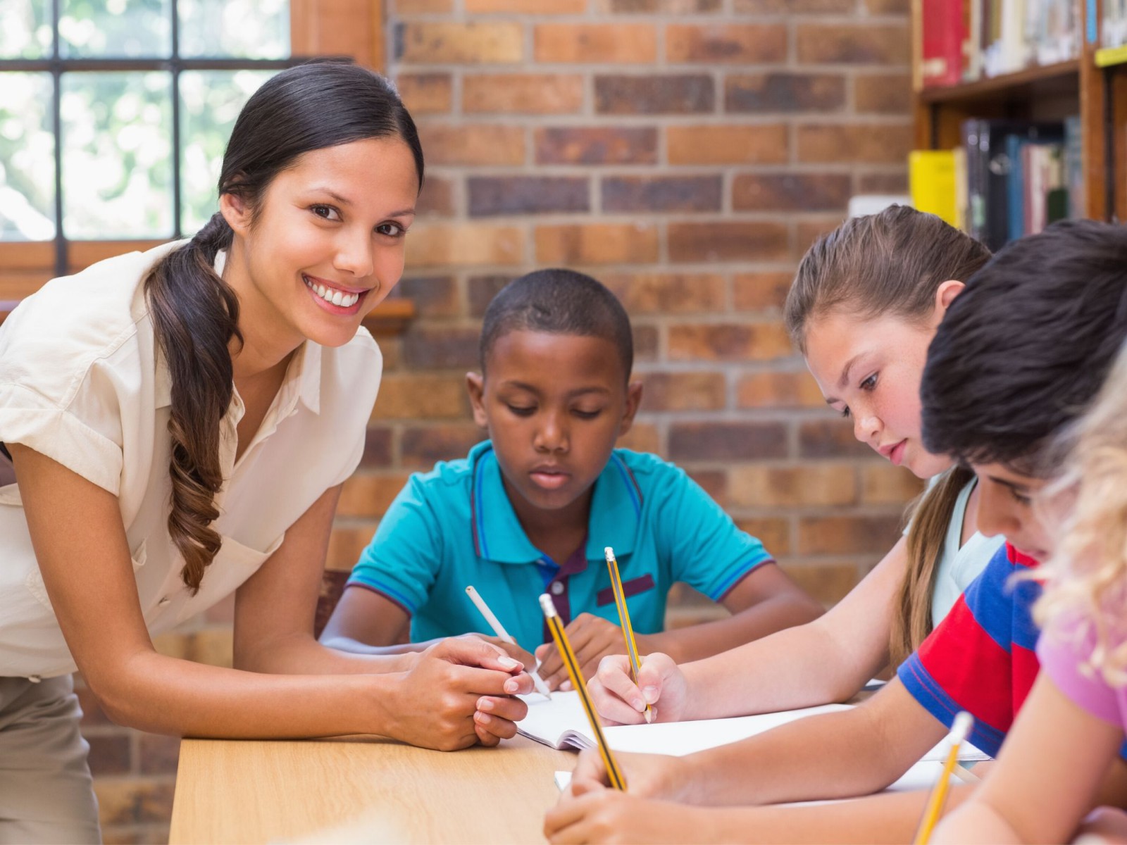 Teacher helping students