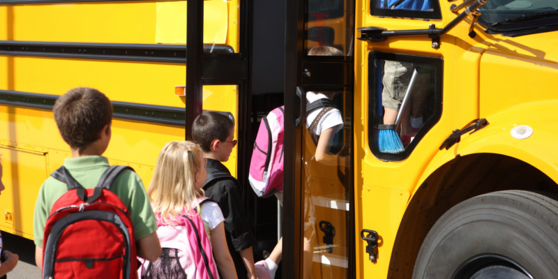 Kids getting on the school bus