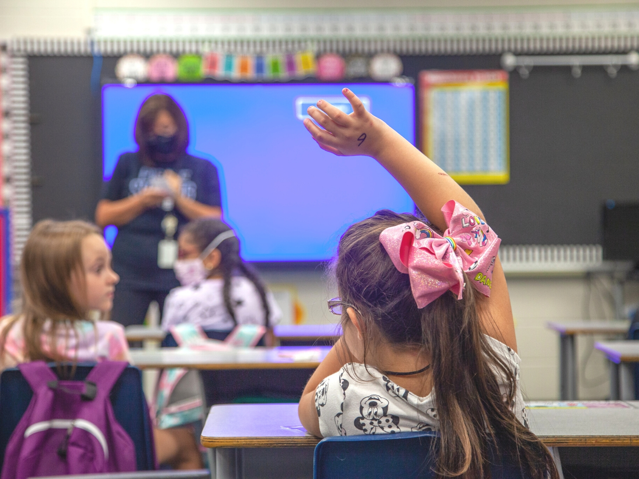 Student raising her hand in class
