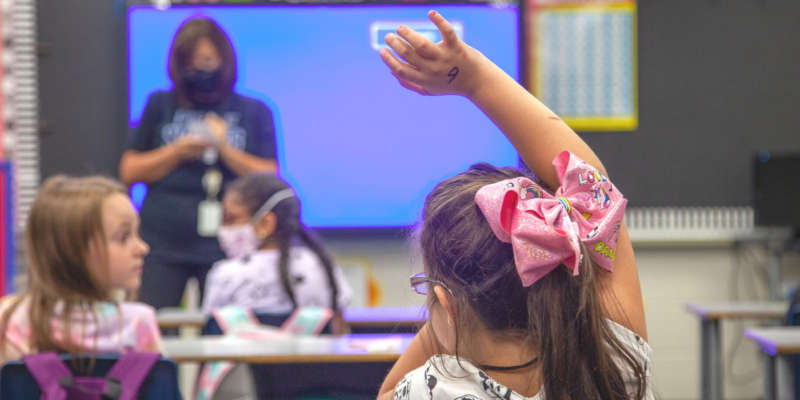 Student raising her hand in class