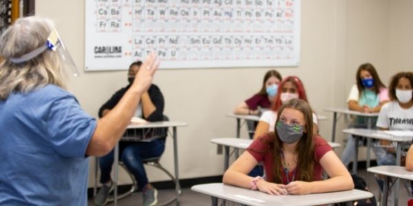 Students listen to teacher