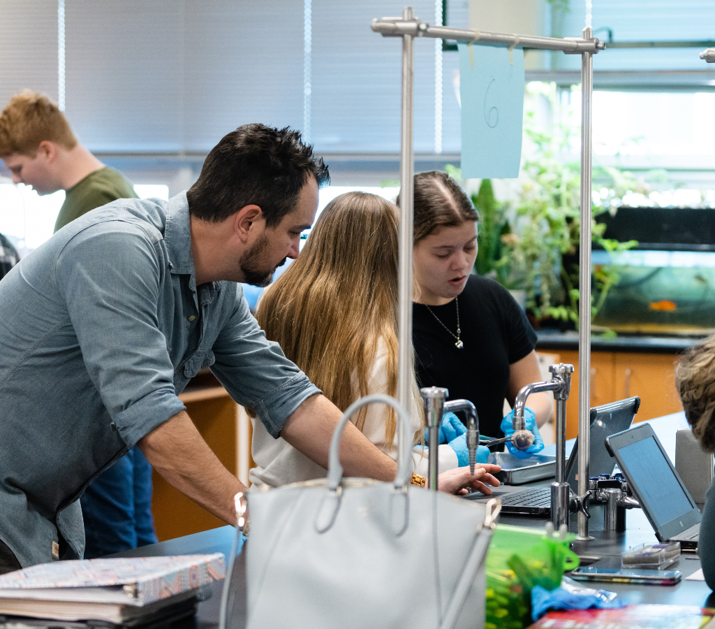teacher assisting students in science class